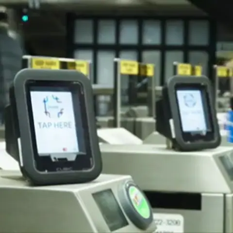 Tapping a Credit Card to Enter a Train Station